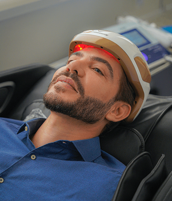 Hair restoration patient relaxing during treatment at Sanabria Clinic