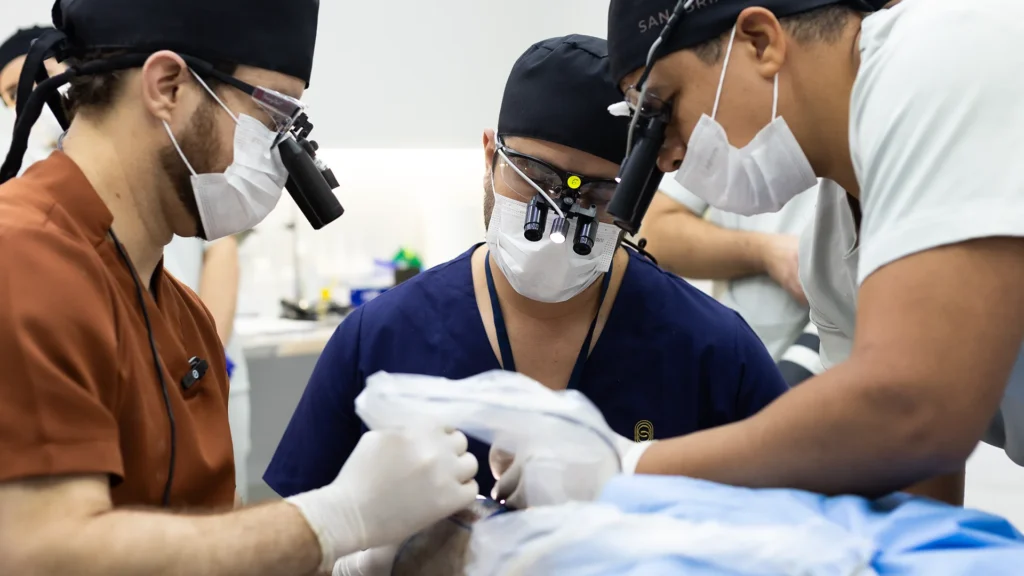 Sanabria Aesthetics surgical team performing hair transplant under magnification